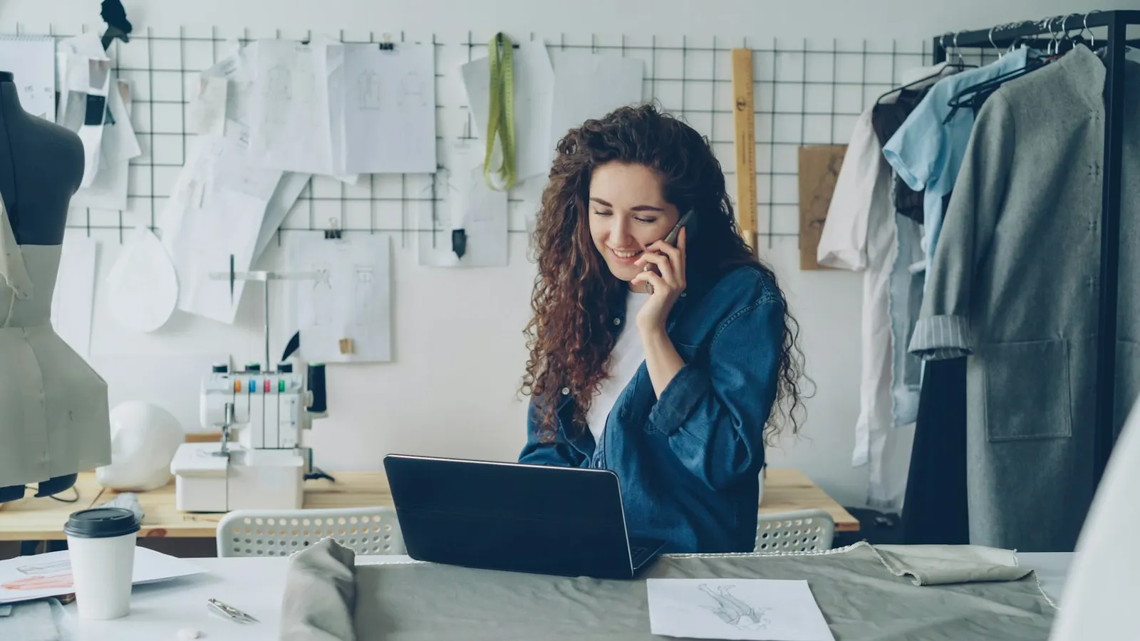 A small business owner on a call at her laptop in her studio