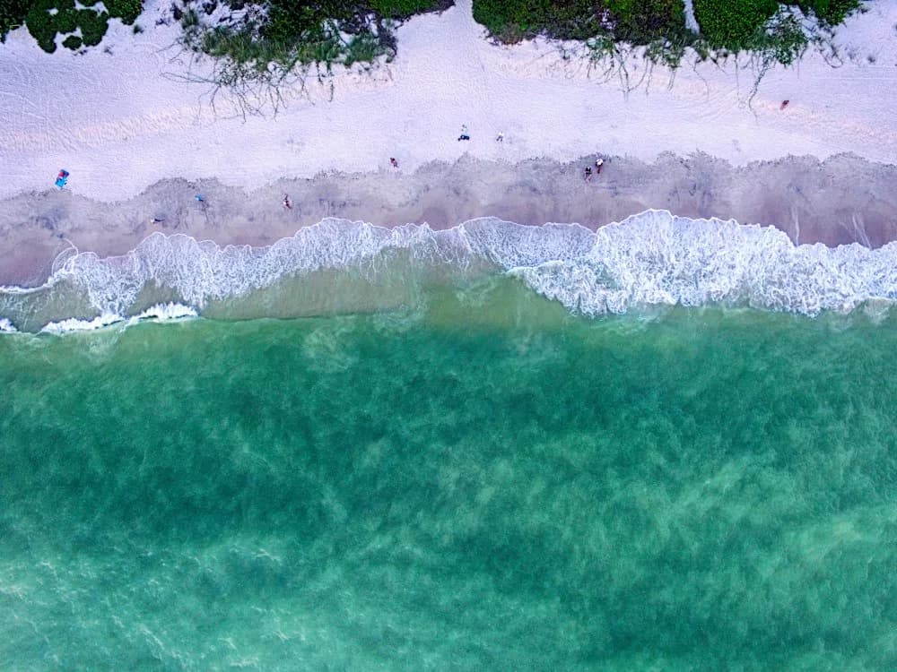 Aerial view of turquoise water and white sand beach