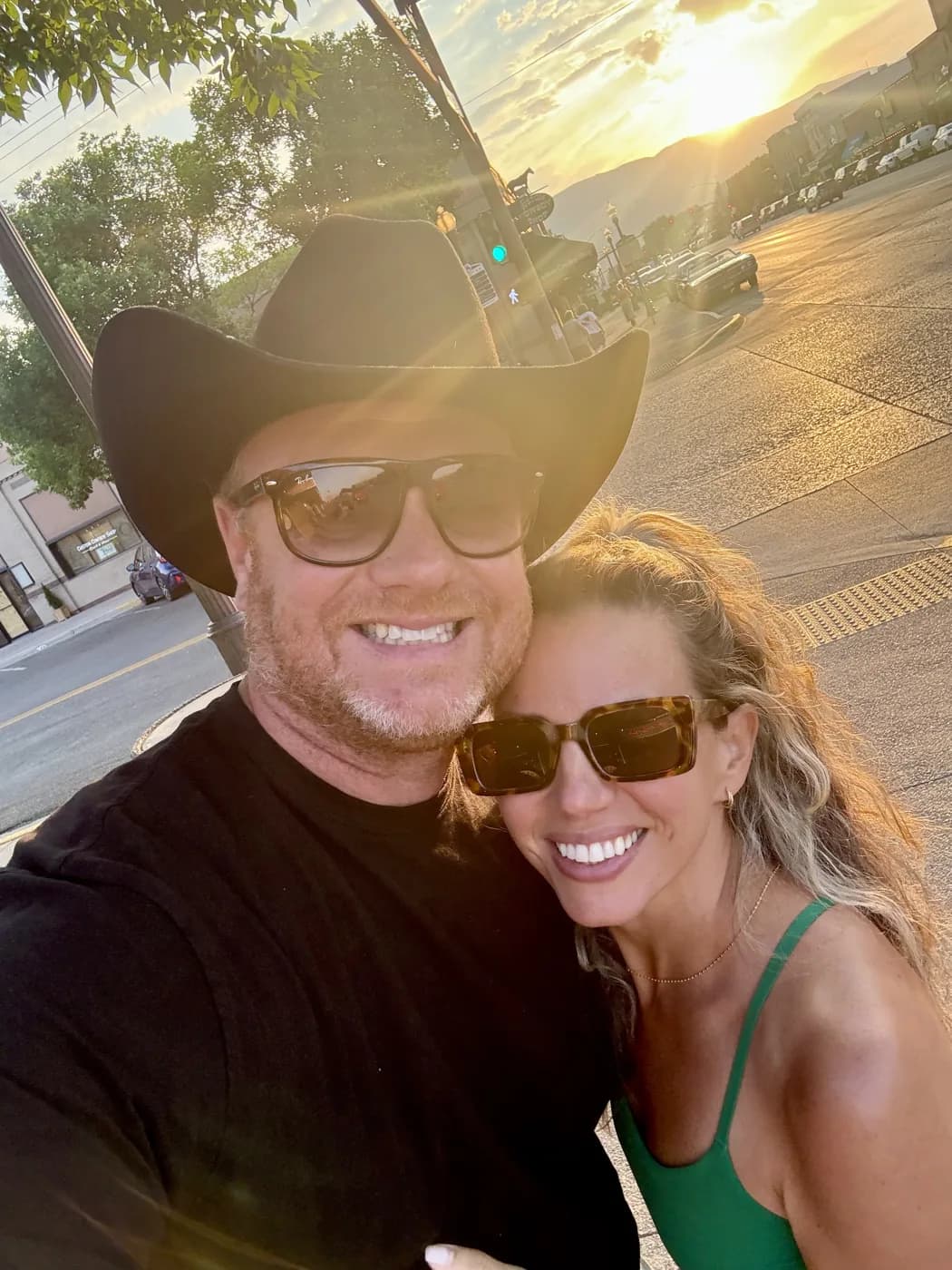 Nicole smiling in sunglasses at golden hour