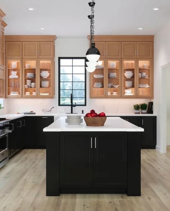 Kitchen with a black island and glass-front wood cabinets