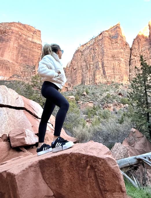 Hiker standing on red rock in a canyon