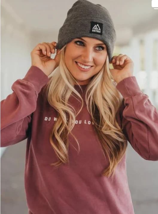Smiling woman in a Hikyoga beanie and sweatshirt