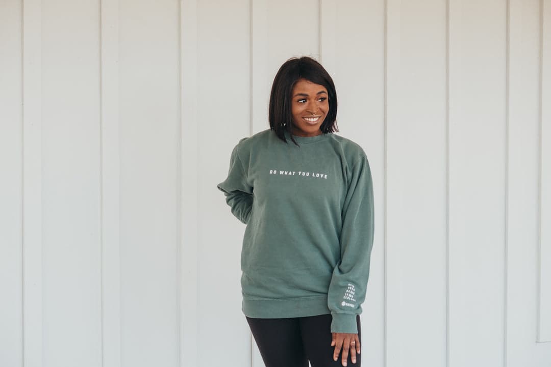 Woman in a green Hikyoga crewneck