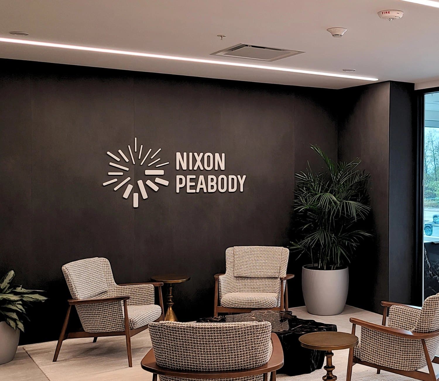 Nixon Peabody lobby with a dimensional logo on a dark feature wall