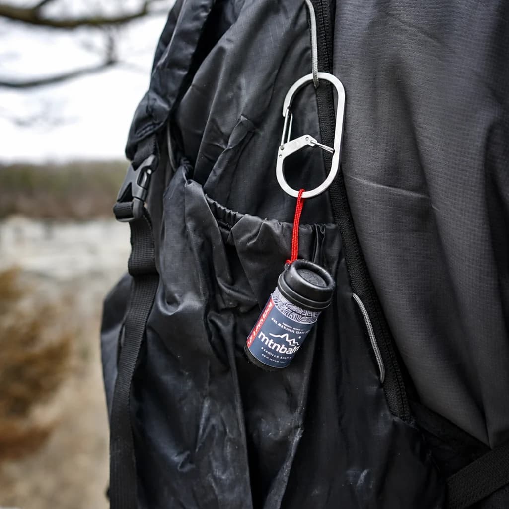 Summit Stick clipped to a backpack by its micro-cord loop