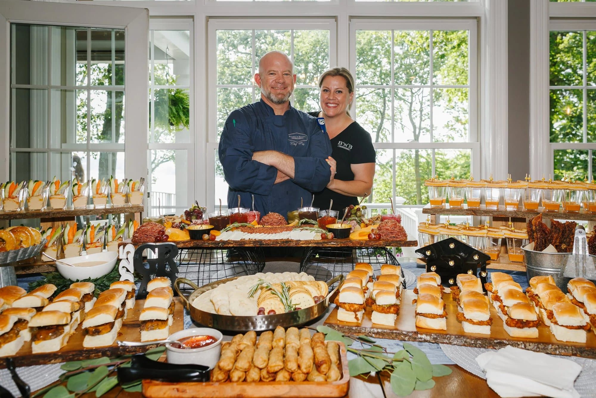 Owners Pete and Jen behind a full catering spread