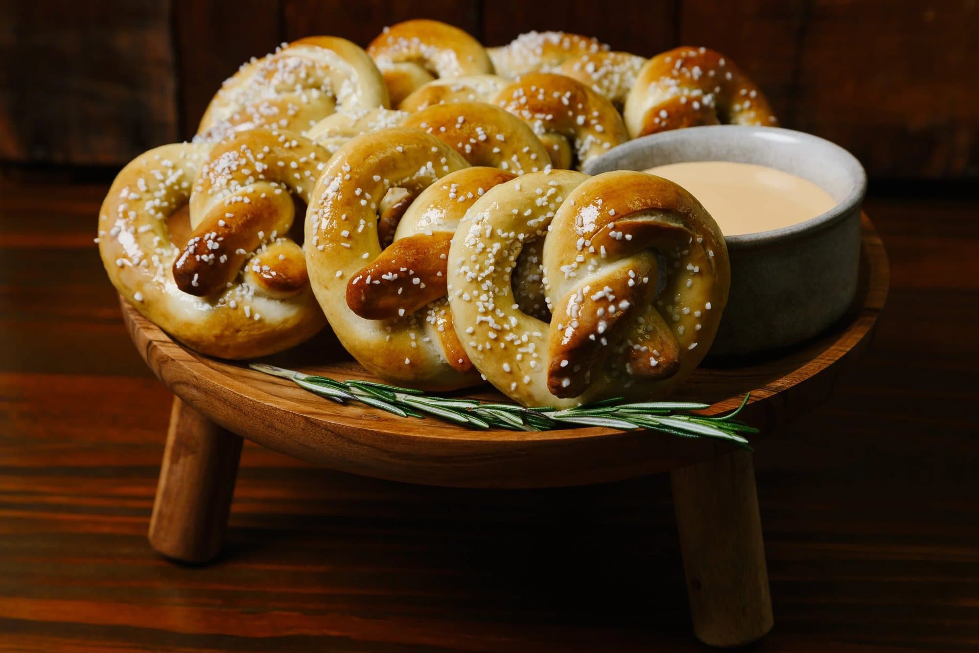 Soft pretzels with beer cheese on a wooden stand