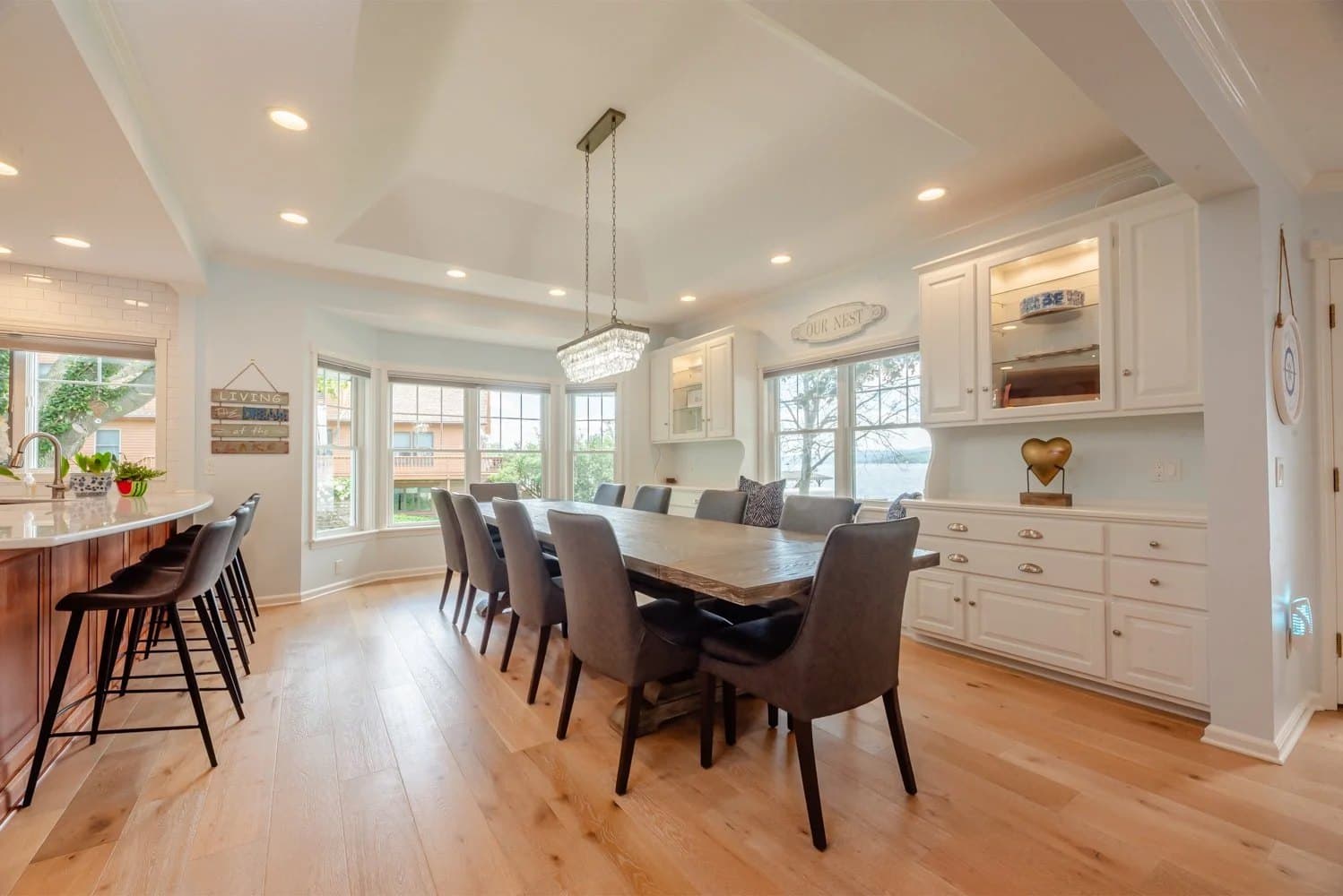 Open kitchen and dining room with a long table and pendant lights
