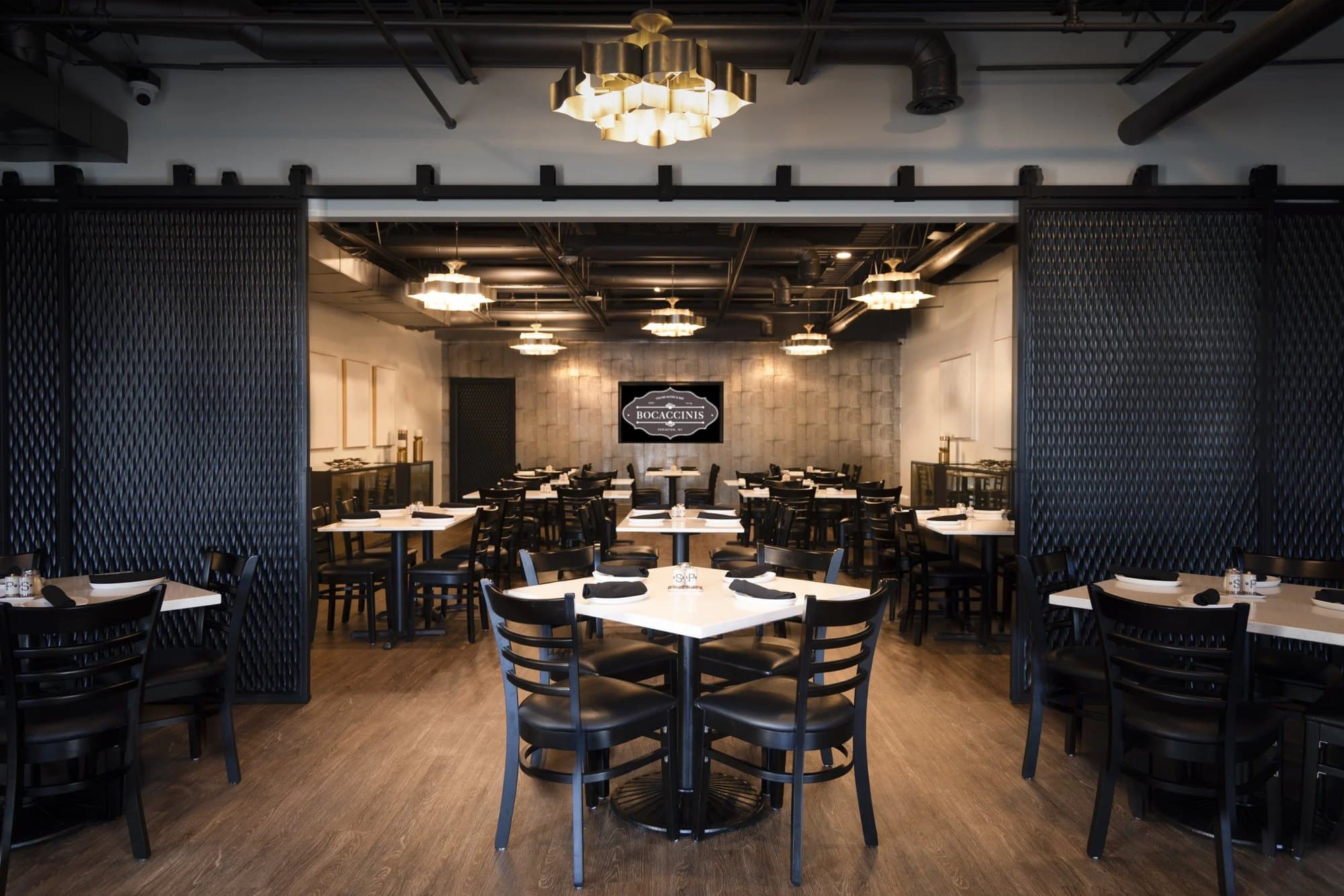 Restaurant dining room with branch chandeliers and large-scale art