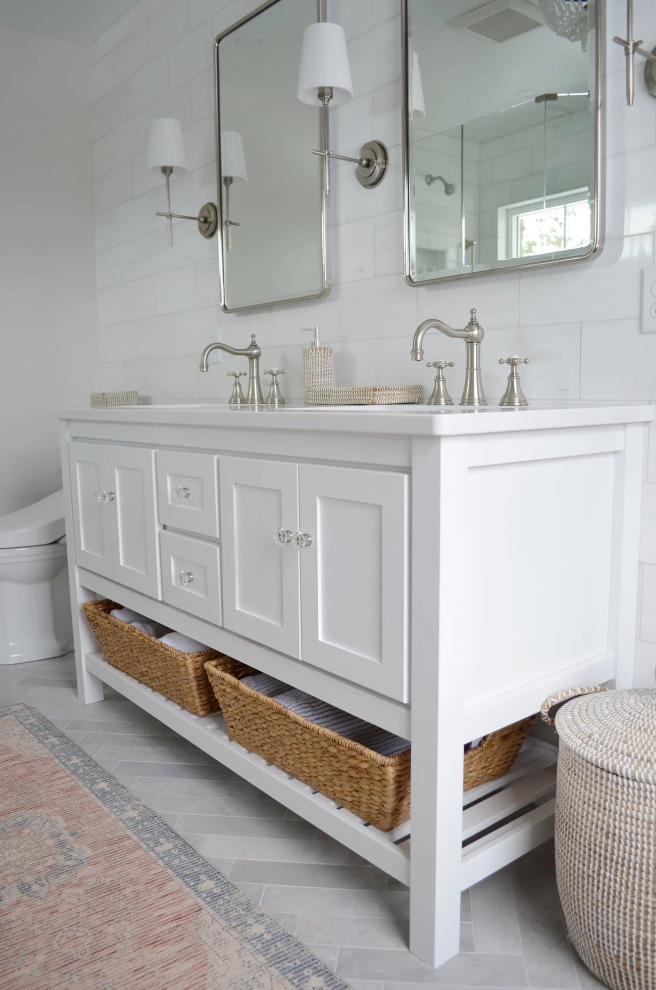 Bathroom vanity with a round mirror and sconces